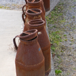Antique Milk Jugs Design next to Carpark