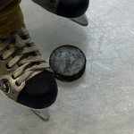 Ice-hockey skates and puck