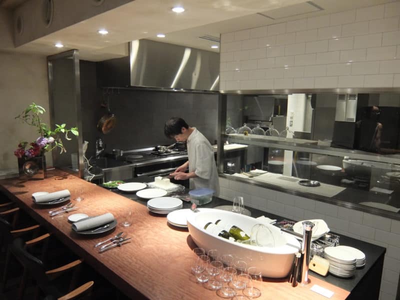 Chef, open kitchen and counter at Michelin starred restaurant Hiroto in Hiroshima, Japan