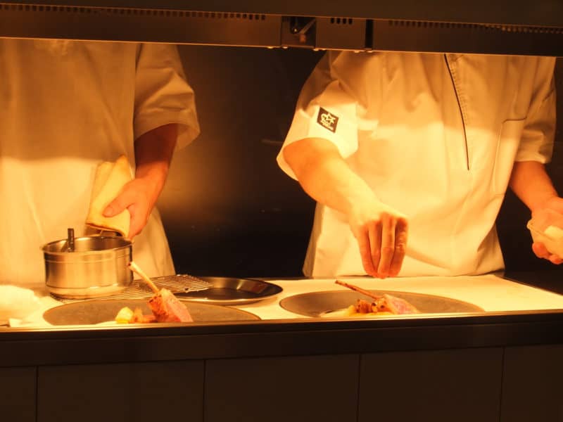 Chefs put the finishing touches to a dish at Michelin starred restaurant Hiroto in Hiroshima, Japan