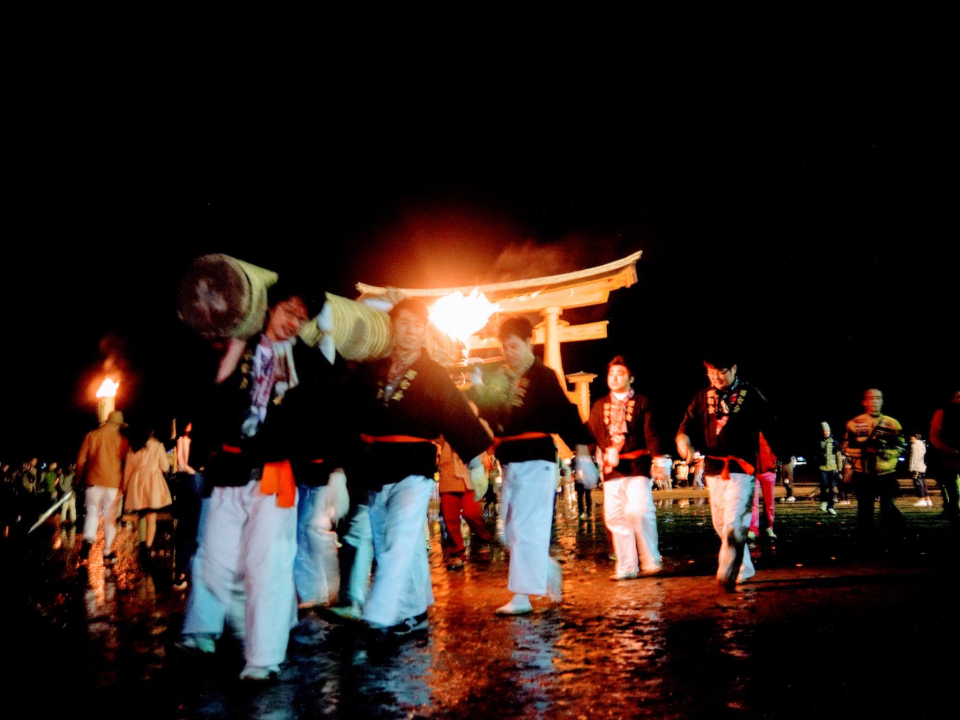 Torches paraded in front of the great torii gate
